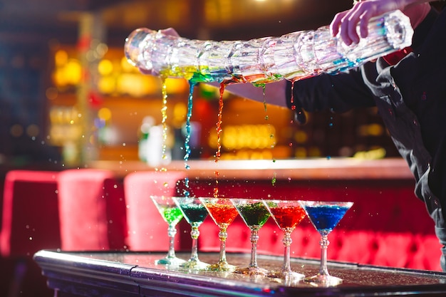 Barman show. Bartender pours alcoholic cocktails.