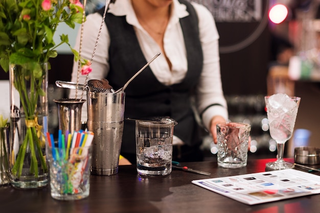 Barman show Female bartender is making cocktail at night club