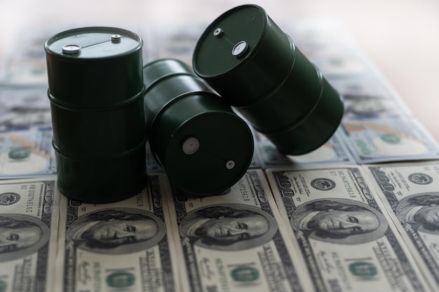 A barrel and dollar bills on a white background.