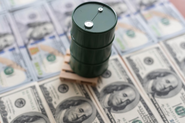 A barrel and dollar bills on a white background.