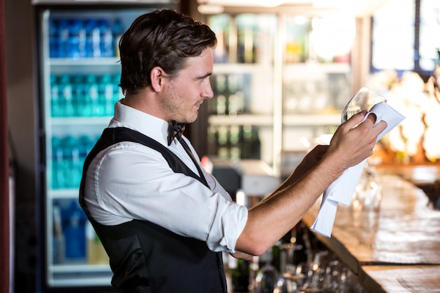 Bartender cleaning wineglass