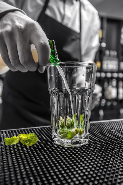 Bartender is pouring lime juice