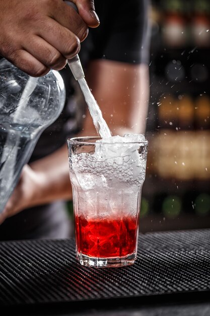 Bartender is pouring soda water