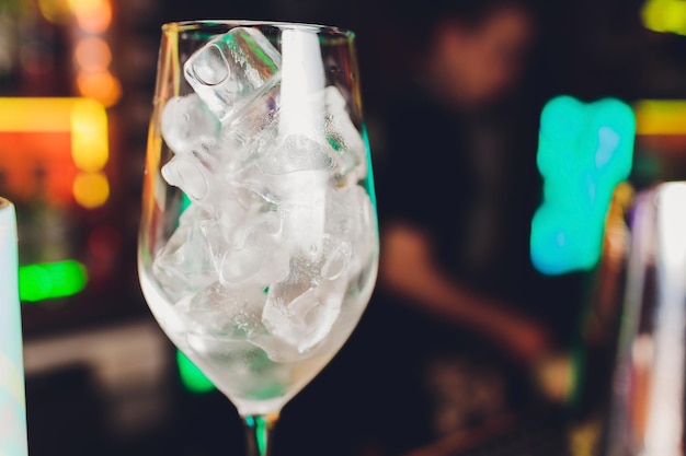 A bartender makes a cocktail over the marble bar counter