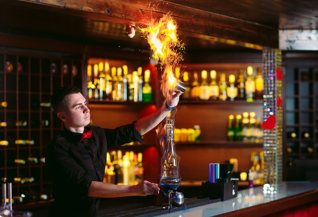 Bartender makes hot cocktail.