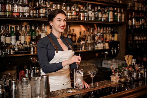 Bartender making a fresh cocktail at the bar