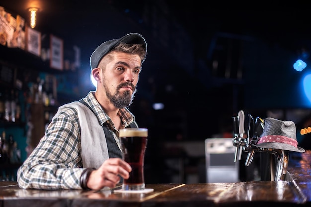 Bartender mixes a cocktail on the beerhouse