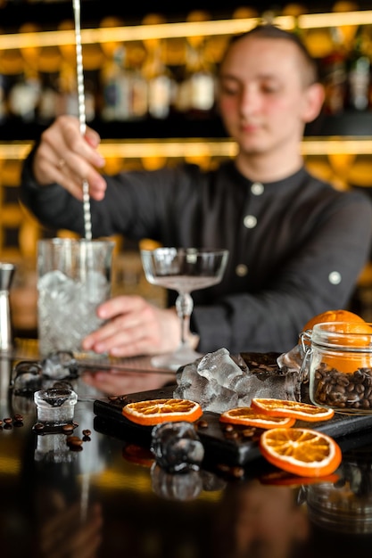 Bartender performing an alcoholic fresh red luxury cocktail at the bar Decorated with oranges