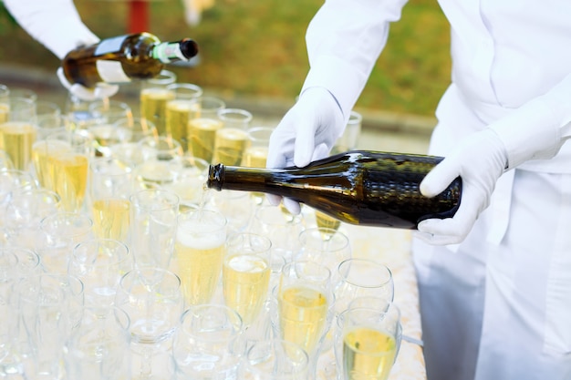 Bartender pouring champagne into glasses