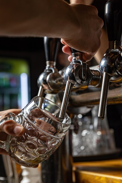 bartender pours beer into a glass at the restaurant bar