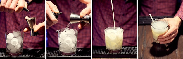 The bartender prepares a cocktail at the club by pouring the ingredients into a glass with ice