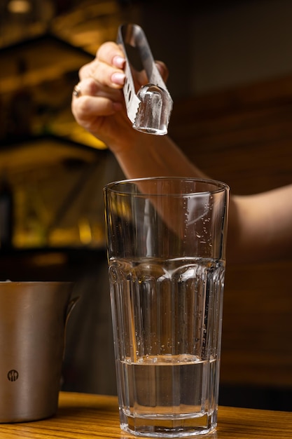 A bartender prepares a cocktail at the restaurant bar