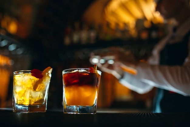 The bartender prepares cocktails at the bar