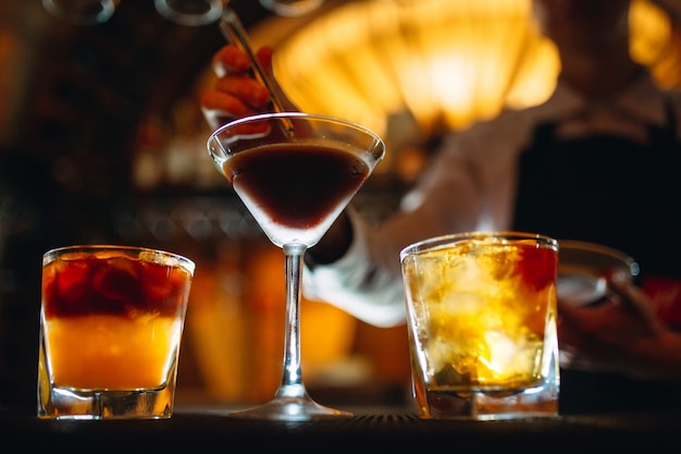 The bartender prepares cocktails at the bar