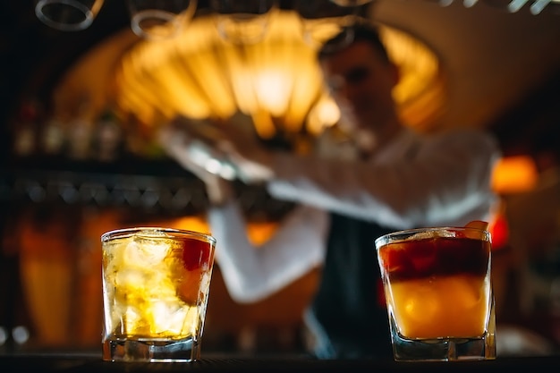 The bartender prepares cocktails at the bar