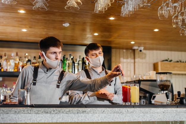 The bartender prepares cocktails in a modern restaurant.