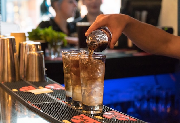 Bartender preparing a cocktail with ice, close-up