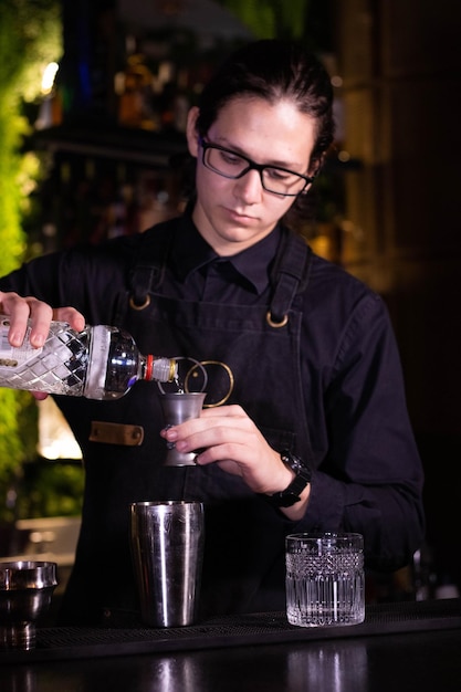 Photo bartender with bottle of vodka