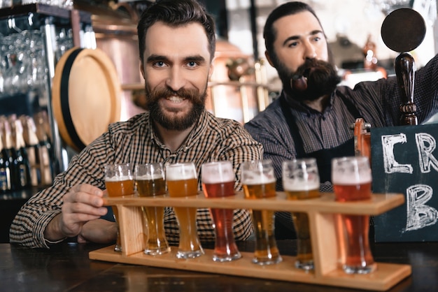 Bartenders Pour Fresh Beer into Glasses in Pub