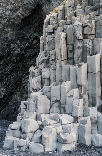 Basalt rock pillars columns at Reynisfjara beach near Vik South Iceland Unique geological volcanic formations Natural stone texture background