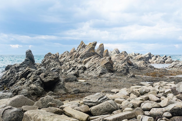 Basalt rocks on the sea coast Cape Stolbchaty on Kunashir Island