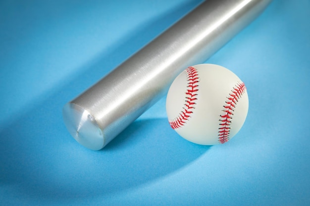 Baseball bat and baseball on the blue background