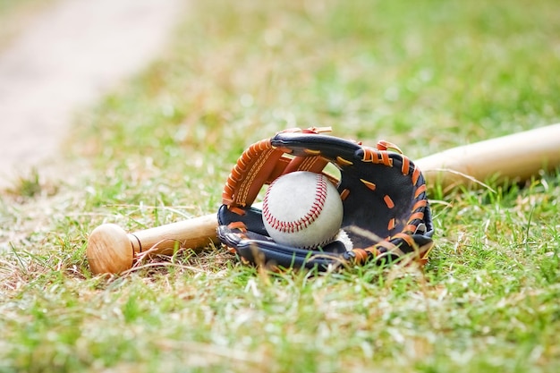 Photo a baseball bat concept with ball outdoors in the park on the field