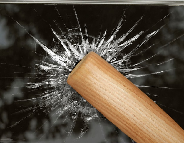 Baseball bat hits through broken glass