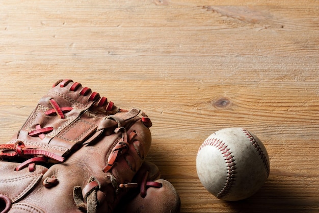 Baseball glove and baseball on wood board sport concept