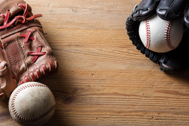 Baseball gloves and baseballs on wood board sport concept