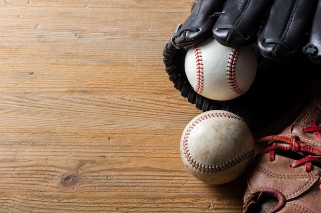 Baseball gloves and baseballs on wood board sport concept