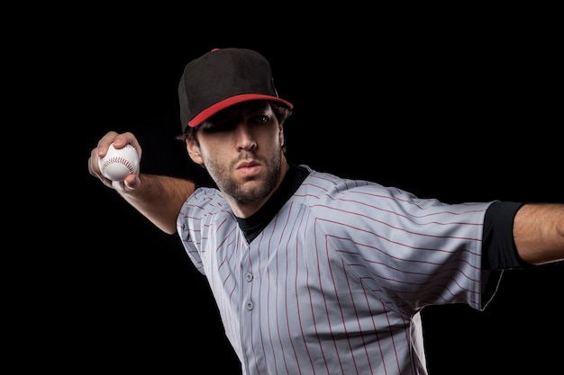 Baseball Player pitching a ball  . Studio Shot.