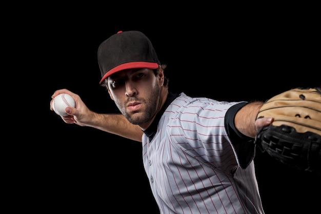 Baseball Player pitching a ball  . Studio Shot.