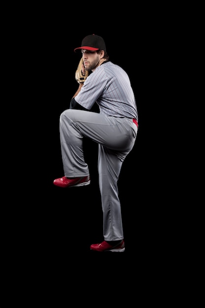 Baseball Player pitching a ball  . Studio Shot.