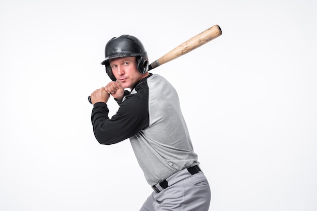 Baseball player posing in helmet with bat