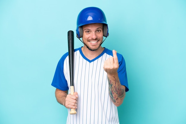 Baseball player with helmet and bat isolated on blue background making money gesture