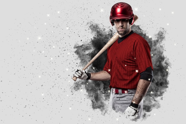 Baseball Player with a red uniform coming out of a blast of smoke .