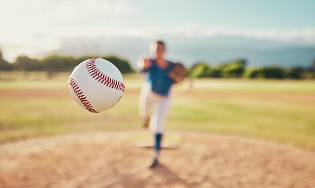 Baseball sport and ball with a sports athlete or pitcher throwing and pitching a ball during a game or match on a court Fitness workout and exercise with an athletic person training outside