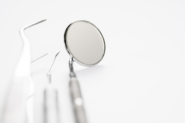 Basic dentist tools on white background.