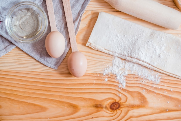 Basic ingredients for baking, egg and flour on table