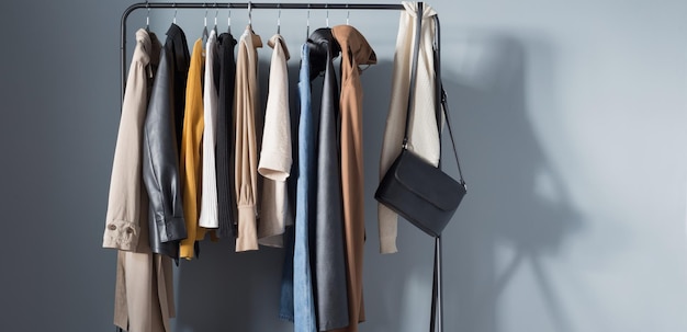 Basic women's autumn wardrobe with shoes and handbags on hanger