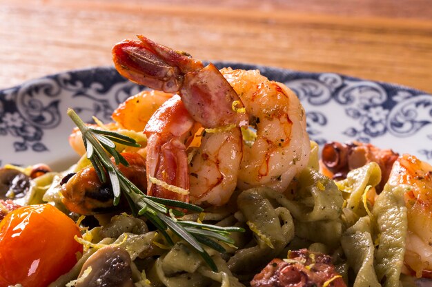 Basil fettuccine with seafood, shrimp and tomato