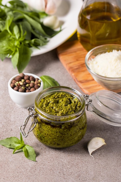 Basil pesto sauce in a jar Ingredients for cooking cheese parmesan garlic olive oil