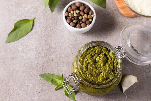 Basil pesto sauce in a jar Ingredients for cooking cheese parmesan garlic olive oil