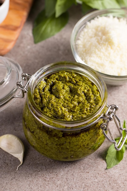 Basil pesto sauce in a jar Ingredients for cooking cheese parmesan garlic olive oil