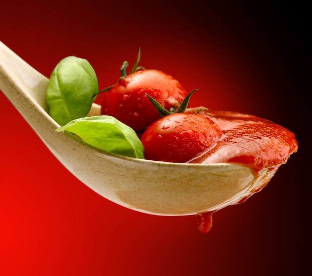 basil and tomato sauce in a spoon