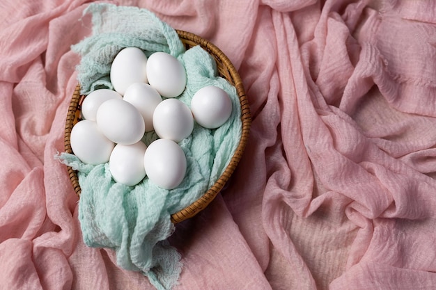 A basket of eggs on a pink cloth