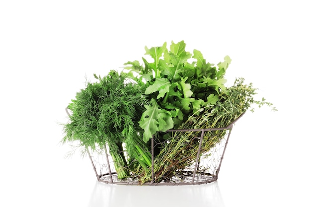 Basket full of fresh herbs isolated on white background