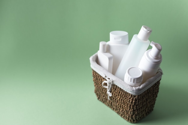 basket full of white plastic cosmetic bottles