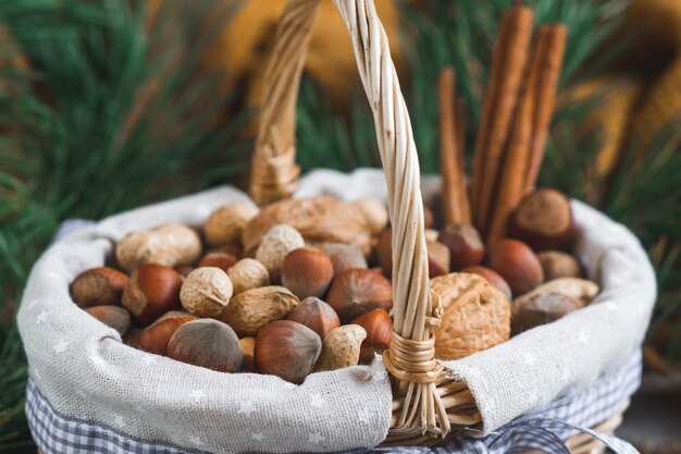 Basket with Assorted Mixed Nuts Peanuts Walnuts Hazelnuts Pine Branch Yellow Blanket Cozy Healthy Concept 